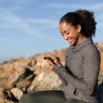 person-looking-at-phone-beach