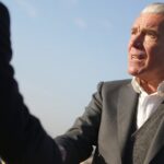 Jordan-Bardella-handshake-businessman