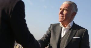 Jordan-Bardella-handshake-businessman