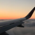 airplane-flying-sunset