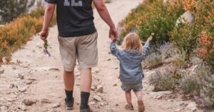 child-walking-with-parent